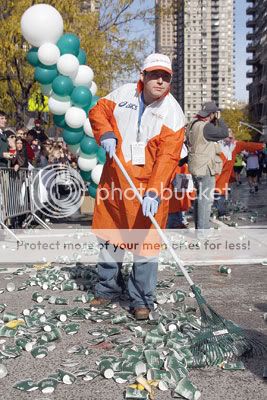 Martathon water2 Adam Bloch rakes up slippery, discarded cups at the corner of 77th Street and First Avenue.