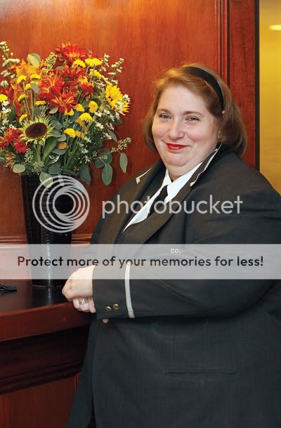 Sharon French watches over the other doormen and hangs candy canes on the lobby Christmas tree for children. Photo by Andrew Schwartz